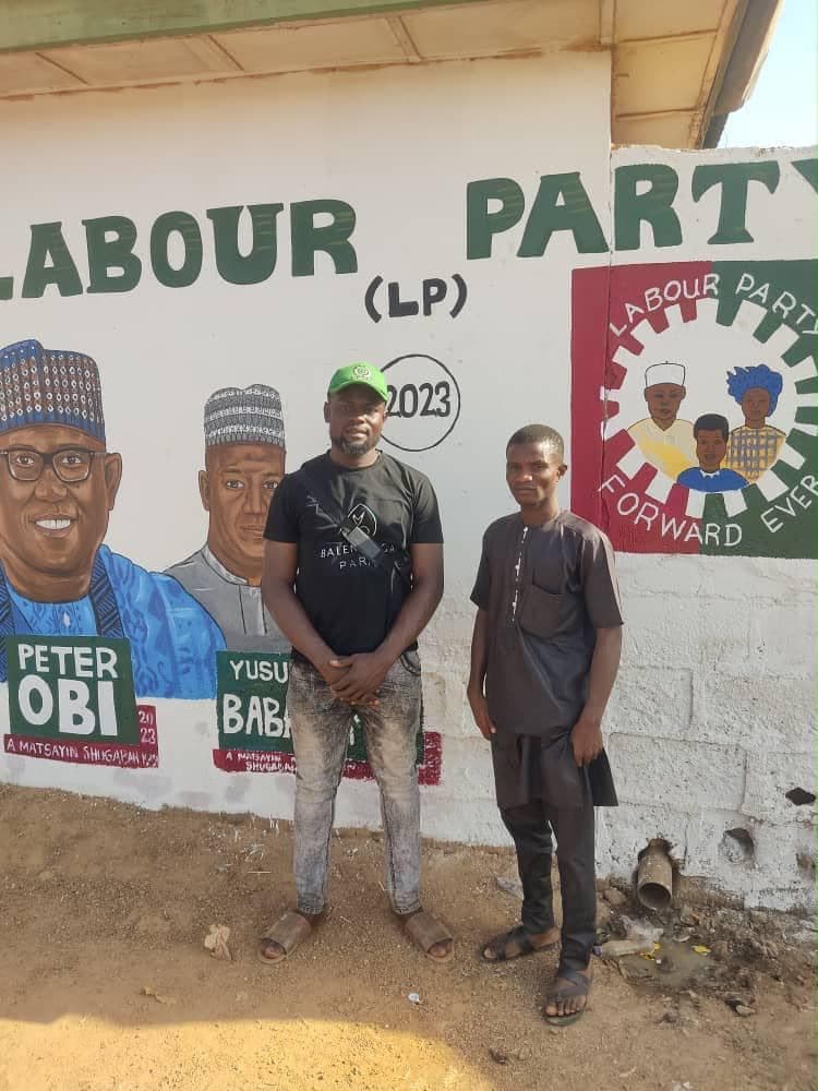 Ambassadors standing beside a finished wall mural.